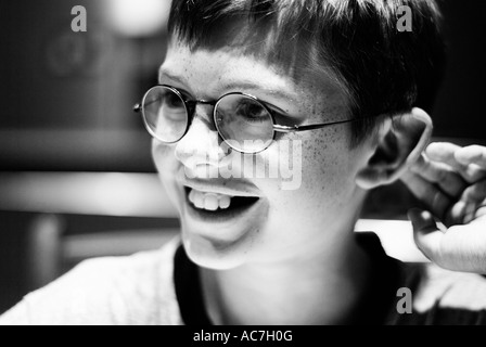 Black and white portrait of a young smiling boy who looks similar to Harry Potter Stock Photo
