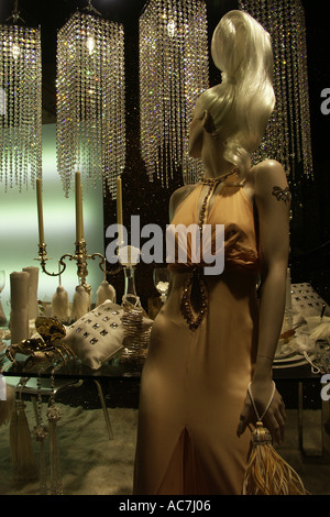 lady mannequin relaxing  in elegant pose by dinner table  in Harrods department store christmas window display london UK Stock Photo