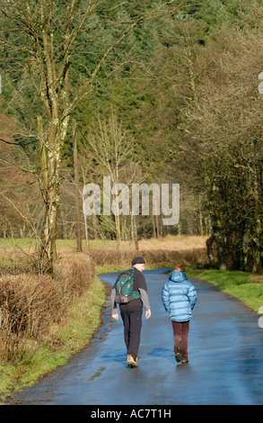 Two walkers on country road near Llanwrtyd Wells Powys Wales UK Stock Photo