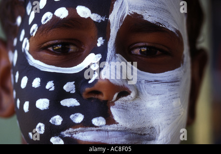 Aboriginal Australian dancer with face paint standing in shadow Stock