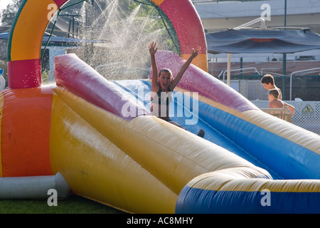 Stock photo of young 12 year old girl in bikini having great fun on a water slide Shot June 2007 Stock Photo