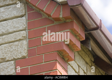 Corbelling or brickwork corbels at gable corners of house Woodmancote UK Stock Photo