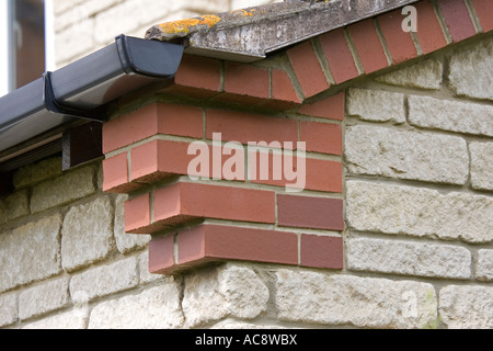 Corbelling or brickwork corbels at gable corners of house Woodmancote UK Stock Photo