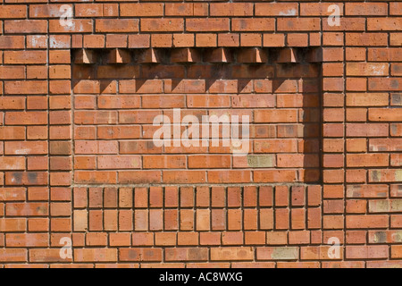 Corbelling in brickwork providing relief pattern on red brick wall Tewkesbury UK Stock Photo