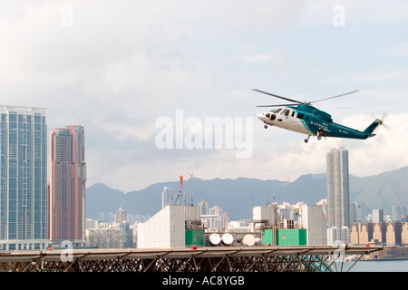 HeliJet Express helicopter lands or take off at heliport shun tak centre hong kong island returning from Macau Hong Kong HKSAR Stock Photo