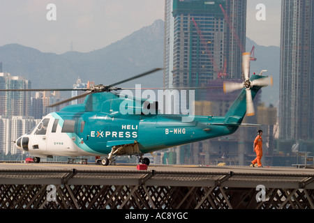 HeliJet Express helicopter lands or take off at heliport shun tak centre hong kong island returning from Macau Hong Kong HKSAR Stock Photo