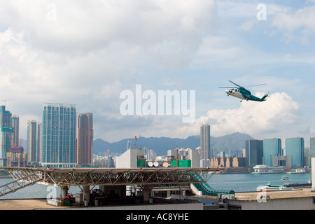 HeliJet Express helicopter lands or take off at heliport shun tak centre hong kong island returning from Macau Hong Kong HKSAR Stock Photo