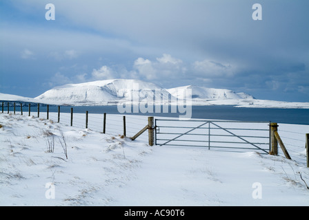 dh  ORPHIR ORKNEY Farm gate in snow Scapa Flow and Hoy hills Stock Photo
