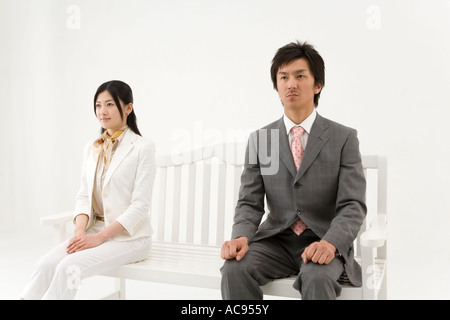 Two business people sitting on bench Stock Photo