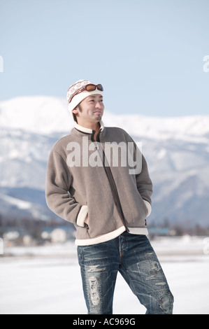 Young man standing in snow Stock Photo