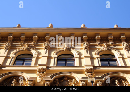 Ornate facade of a historic building in the old part of Prague, Czech Republic, with intricate architectural details against a clear blue sky. Stock Photo