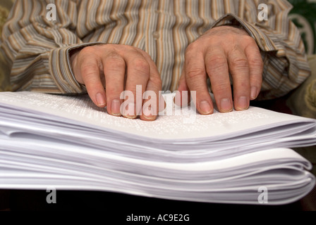 Blind man reading braille London UK Stock Photo