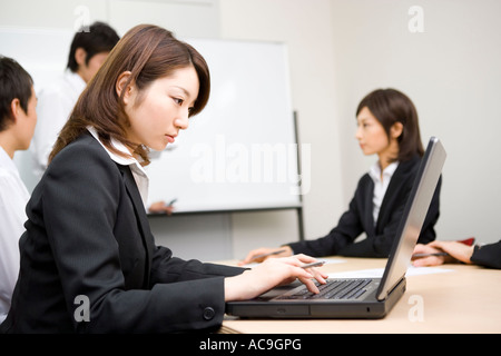 Young businesswoman using laptop Stock Photo