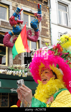 colourful lady with camera in street carnival dressed in garish colours celebrating carnival Maastricht Netherlands Stock Photo