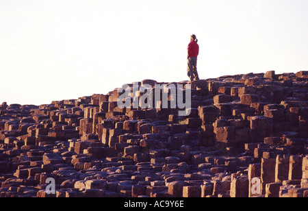 Person on the hexagonal basalt columns of the Giants Causeway, Co Antrim, Northern Ireland Stock Photo