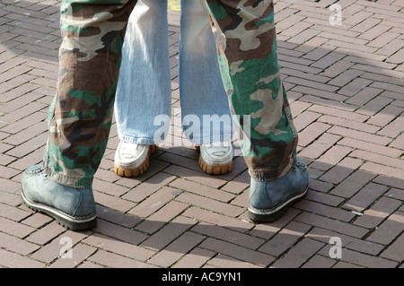 close up of feet and legs of young loving couple standing close facing each other Stock Photo