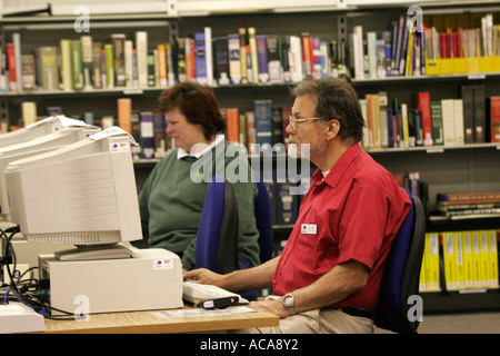 Male & female mature students using computers at adult education centre London GB UK Stock Photo