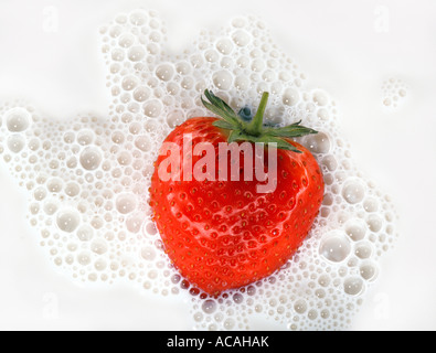 Strawberry in milk with bubbles Stock Photo