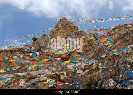 Tibetan Buddhism many colourful prayer flags at steep mountain Drak Yerpa Tibet China Stock Photo