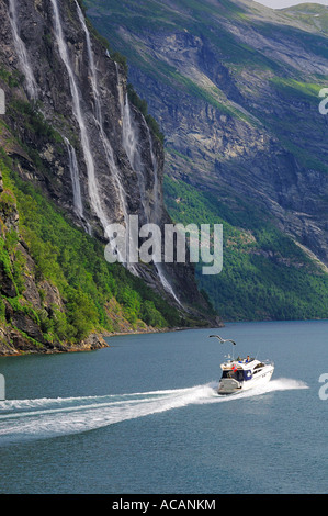 Motor yacht in front of waterfall: The seven sisters, Geiranger Fjord, Hellesylt, More og Romsdal, Norway Stock Photo