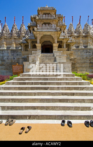 Close up wide angle of the steps and pairs of shoes at the main entrance of the Adinatha Jain Temple in Ranakpur. Stock Photo