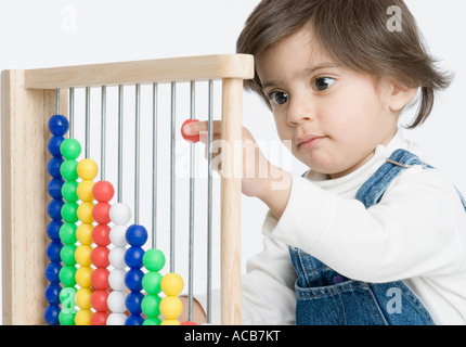 Close-up of a boy playing with an abacus Stock Photo