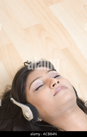 Close-up of a young woman wearing headphones and listening to music Stock Photo