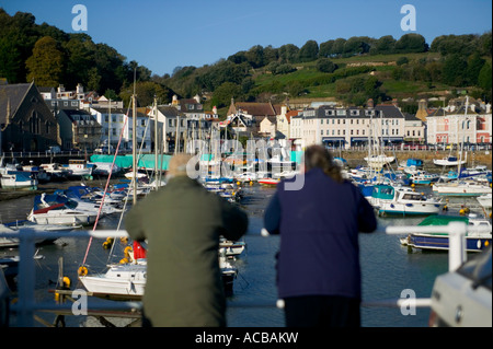 Boat owners looking at St Aubins harbour during an early winters morning Jersey Channel Islands Stock Photo