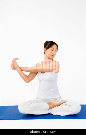 Woman sitting on floor stretching Stock Photo - Alamy