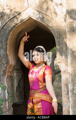 Young woman performing Bharatnatyam in an archway Stock Photo