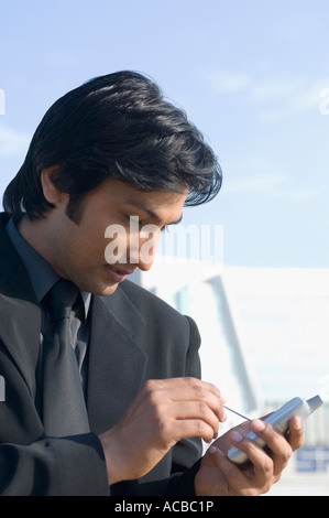 Close-up of a businessman using a personal data assistant Stock Photo