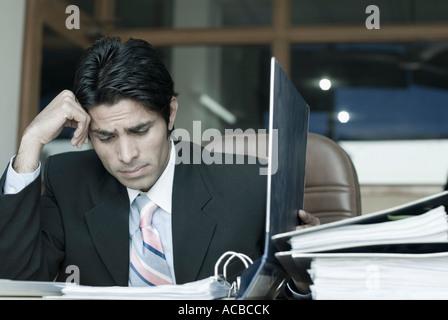 Businessman looking at a file in an office Stock Photo
