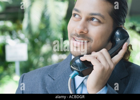 Close-up of a businessman talking on a pay phone Stock Photo