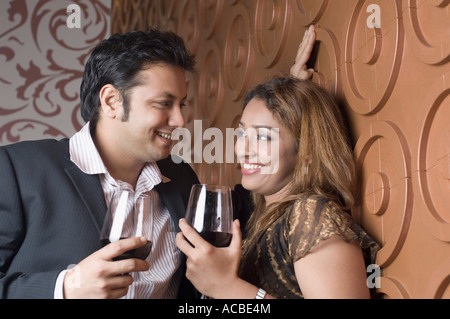 Young couple holding glasses of red wine Stock Photo