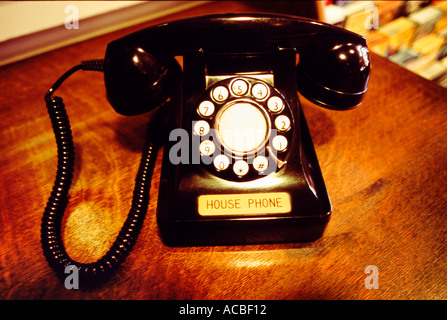 Rotary dial telephone on desk in hotel lobby Stock Photo