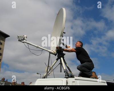 Technician setting up a TV satellite link in Leeds, Yorkshire. Stock Photo