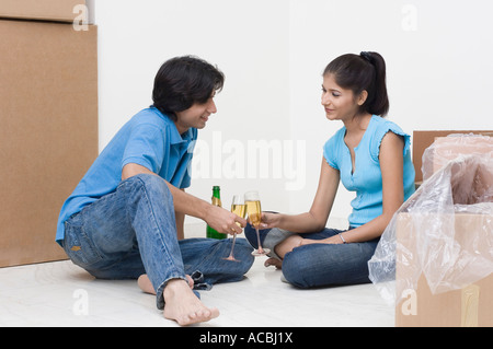 Young couple toasting with champagne flutes Stock Photo