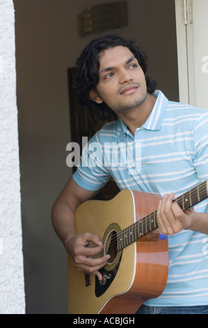 Young man playing a guitar Stock Photo