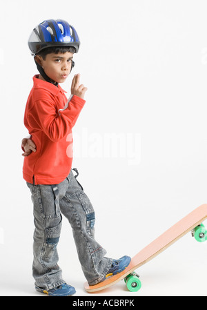 Side profile of a boy standing on a skateboard Stock Photo