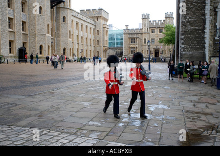 Two Royal Guards marching across at the Tower of London UK Stock Photo