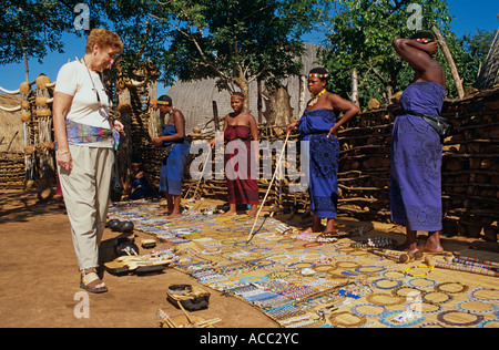 Tourist looking at handicrafts at Zulu tourist village, South Africa Stock Photo