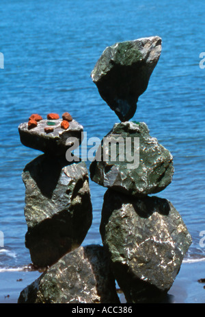 Man made balanced rocks near shoreline Stock Photo