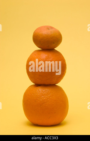 stacked up mandarin oranges concept financial balance Stock Photo