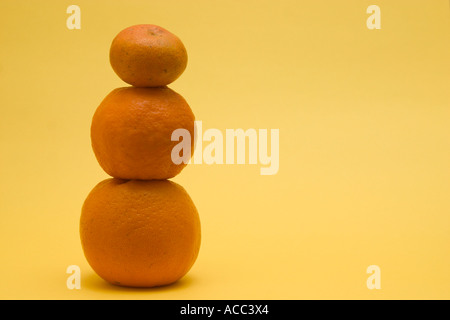 stacked up mandarin oranges concept financial balance Stock Photo