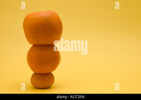 stacked up mandarin oranges concept financial balance Stock Photo