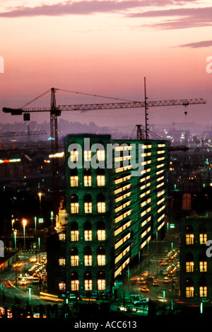 High rise building and cranes at sunset in city Stock Photo