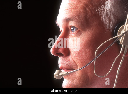 male telemarketer working with headset telephone Stock Photo