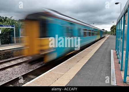 Railway or Railroad Station and Speeding Train Stock Photo