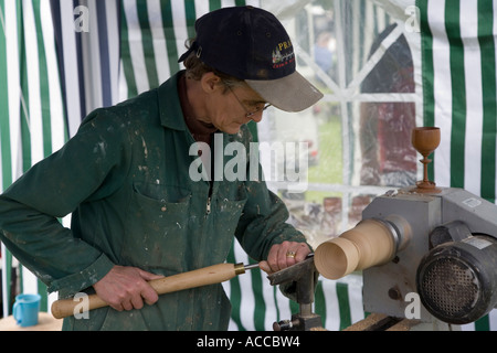 Wood turning demonstration making a goblet on a lathe Wales UK Stock Photo