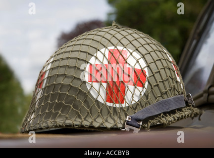 American Second World War US military medical red cross helmet on the hood of a jeep at a display UK Stock Photo